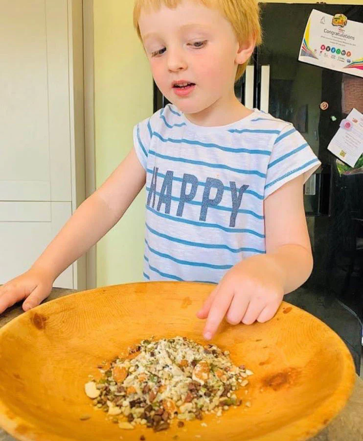 Smiling child eating fruit